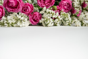 white dried flowers statice and rose raspberry peony on a white background . space for text