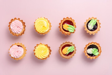cupcakes with cream on pink table