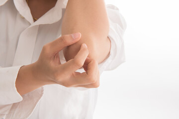Close up women scratch the itch with hand isolated on white background, Concept with Healthcare And Medicine. Itchy skin, girl scratches elbow..