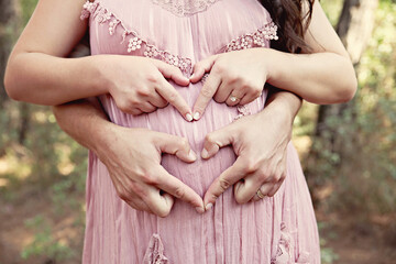 A pregnant couple with nice dresses