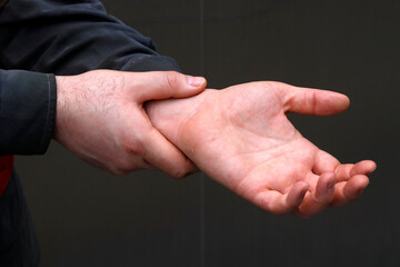 Man massaging his wrist after working