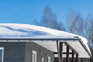 Winter. Snow on cars after snowfall. The car is dark and stands under the snow.