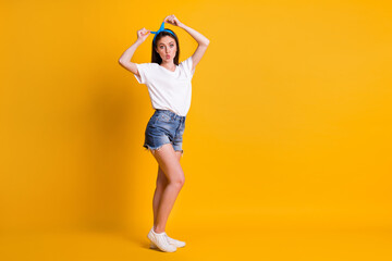 Full length body size photo portrait of girl touching headband sending kiss isolated on vibrant yellow color background with copyspace