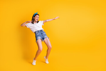 Fototapeta na wymiar Full length body size view of lovely skinny funky cheerful girl having fun moving dancing isolated over vivid yellow color background