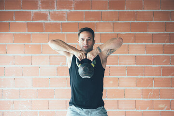 Fit man on a kettle bell routine