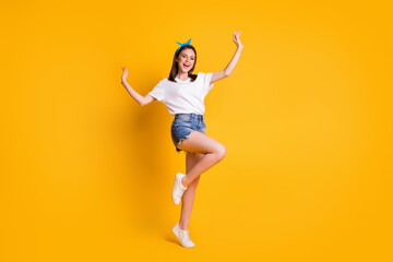 Full length body size view of pretty cheerful brown-haired girl jumping enjoying free time isolated over bright yellow color background