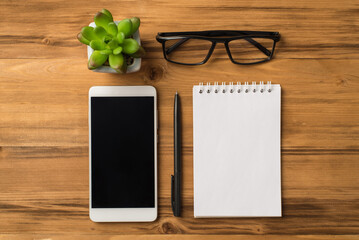 Above overhead close up flat lay view photo of digital smart device gadget flowerpot eyewear spiral...