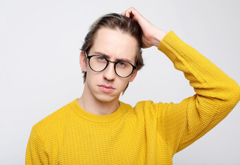 Lifestyle and body language concept: Handsome young man wearing eyewear suffering from headache