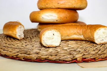 Bagels with poppy seeds with a white mug in the background.