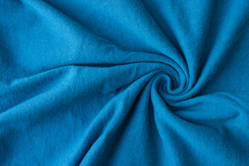 Fototapeta na wymiar Blue fabric knitwear in a fold. Texture, background