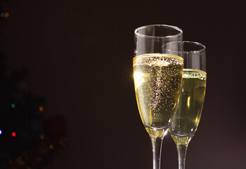 Champagne glasses on a dark background. The concept of the celebration.