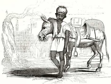 Young Egyptian donkey driver outdoor posing to front hugging his animal. Ancient grey tone etching style art by Sears, Magasin Pittoresque, 1838