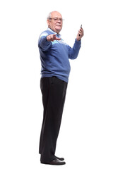 in full growth. the older man is choosing a contact in his smartphone