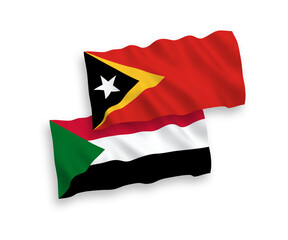 National vector fabric wave flags of East Timor and Sudan isolated on white background. 1 to 2 proportion.