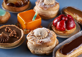 Various French desserts on blue wood board
