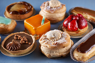 Various French desserts on blue wood board