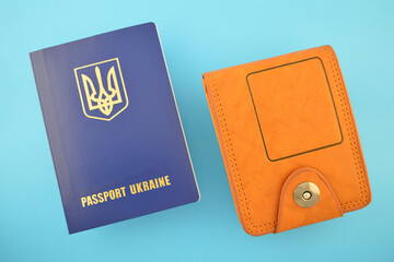 Passport of a citizen of Ukraine and a wallet on a blue background.