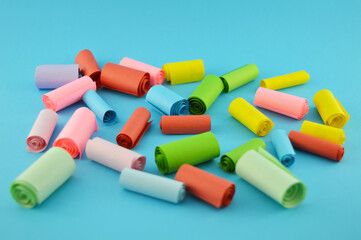 Cribs of multicolored paper on a blue background.