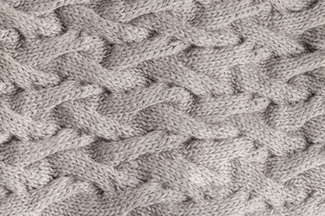 Knitted fabric, gray scarf with a pattern of wool yarn