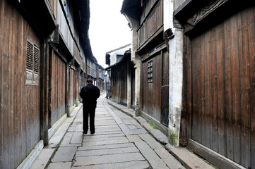 Fototapeta na wymiar Man walking in a hutong