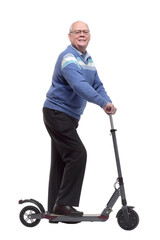 side view. happy senior man with electric scooter