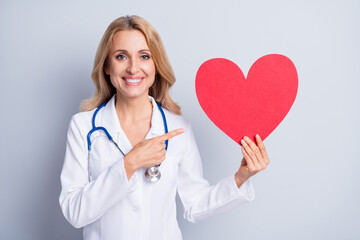 Photo of pretty charming age woman therapist dressed white coat pointing finger red heart isolated...