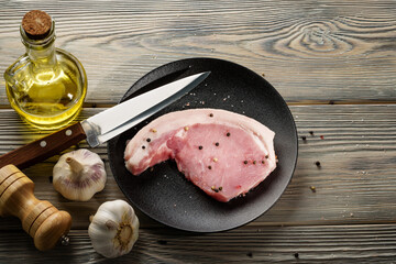 A raw piece of lard on a platter.