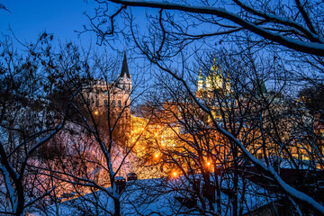 View through the branches of trees to Andriyivskyy Uzviz Descent with Saint Andrew's Church in Kyiv, Ukraine.