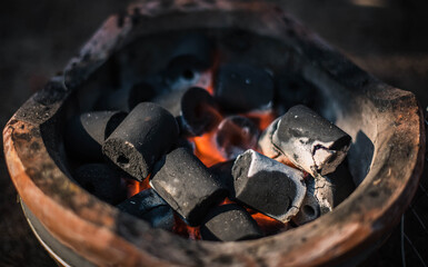 Charcoal is burning in an ancient clay kiln.