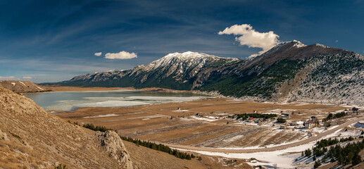 a frozen lake with a mountain in the background