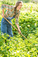 Young gardener working in summer garden. Farming as a hobby