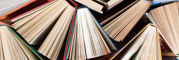 Fototapeta premium Many stacks of books. Old hardback books as background. Back to school