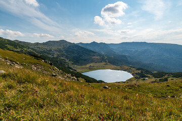 Retezat mountains with peaks and Zanoaga lake in Romania