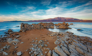 winter landscape with rocks on the shores of the lake