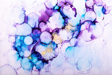 Abstract alcohol in background in gold, purple and blue tones.