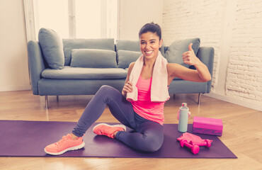 Attractive woman on laptop in virtual online fitness class working out at home