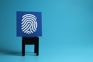 Close up security thumbprint icon on a card isolated on a blue background, copy space for text