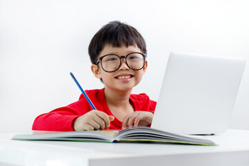 Portrait of a cute little Asian boy using laptop at home, online, video chatting, education,...