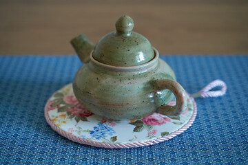 Pottery, a ceramic product with your own hands, made on a potter's wheel, a teapot, a mug.