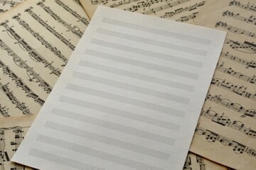 A blank  of sheet music on a background of old vintage notes
