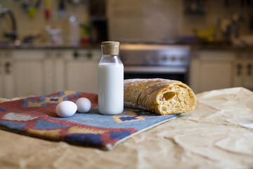 Basic  products for food and simple life. Ingredients for cooking. Bottle of milk, eggs and bread. Food for usual simple breakfast in white kitchen. Organic food. Farmer's food. Simple eating.