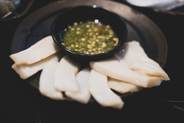 Fresh raw abalone slice served with seafood sauce