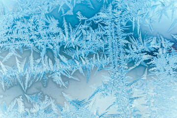 Ice patterns on frozen glass. Abstract ice pattern on winter glass as a background image. Copy, empty space for text