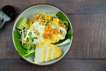 Stir fried noodles or pad mee korat served with Fried Vietnamese pork sausage
