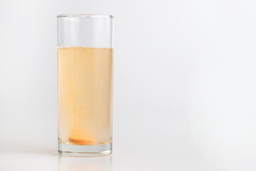 Orange effervescent tablet dissolving in water