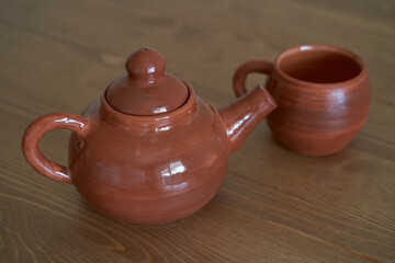 Pottery, a ceramic product with your own hands, made on a potter's wheel, a teapot, a mug.