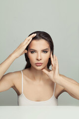 Face gymnastics concept. Beautiful woman holding her hands near her face. Massage, face gymnastics and cosmetology concept