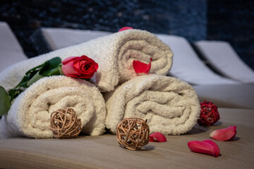 Closeup of towels folded in a pyramid with rose paddles and decoration.