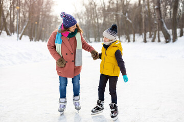 Little boy learning how to ice-skate
