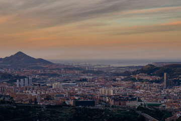 view of the city of bilbao from a mount at sunset